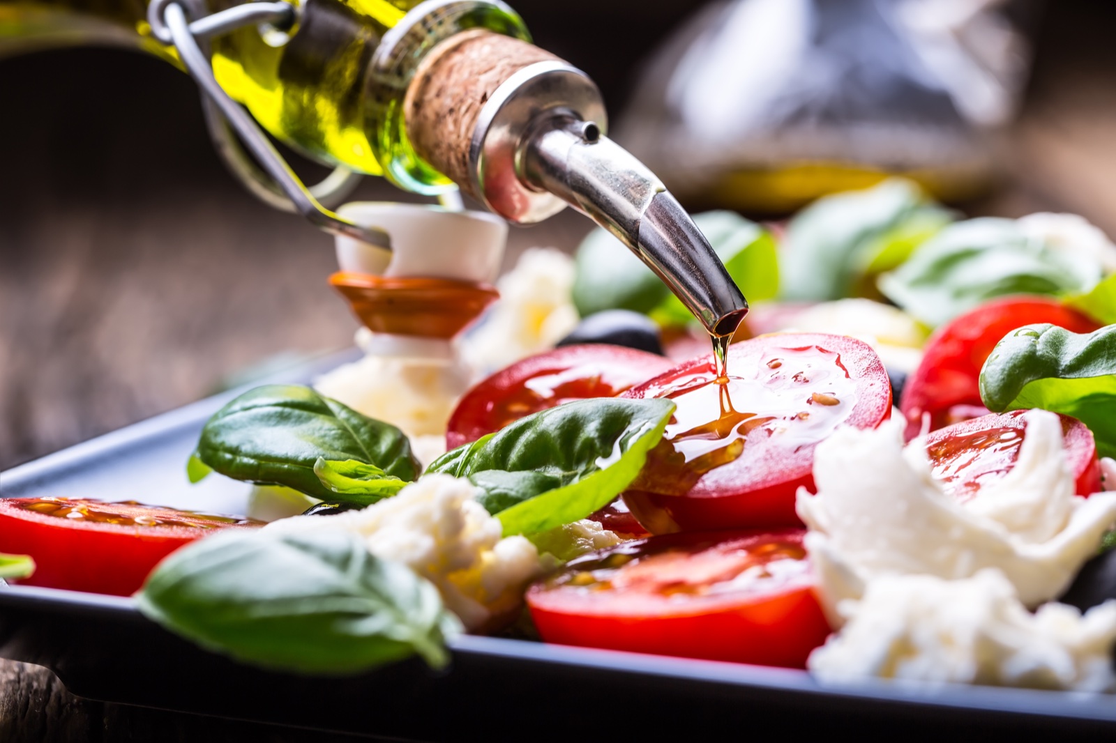 Tomatoes, mozzarella and basil dressed with olive oil