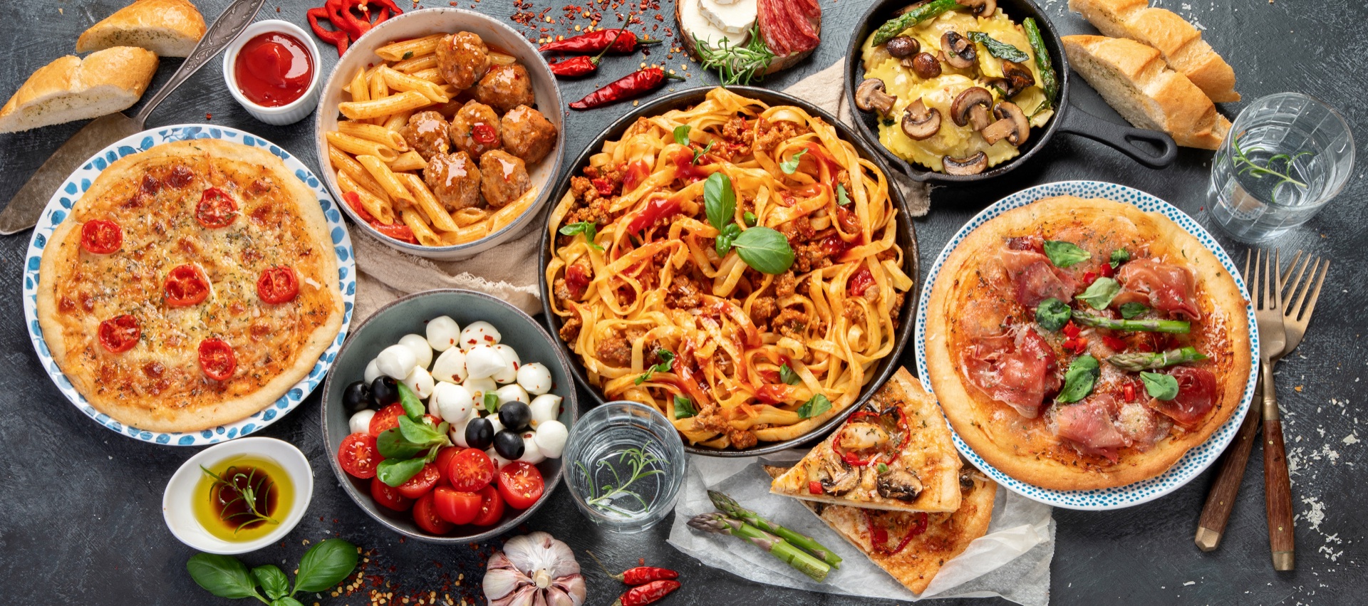 Italian pasta, pizza and antipasti arranged for sharing